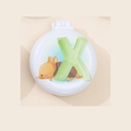White folding travel hair brush with mirror featuring cartoon hedgehog and green X - Letter X
