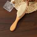 Detail of soft natural wool bristles and smooth beechwood handle for baby hair care - Ellipse