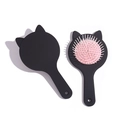 Cute cat-shaped hairbrush with pink air cushion and black frame on a clean white background - Black and Pink (Cat Ear Style)