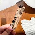 Classic leopard print acetate hair comb with tortoise shell pattern on a wooden table - Beige Tortoise Shell