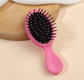 Mini portable hairbrush with pink handle and black cushion for scalp massage - Red