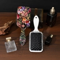 Floral printed and white air cushion massage hairbrushes on a vintage wooden table - Standard Type / New 2