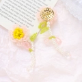 Close-up of handmade bead woven flower charms with pearls and crystal pendants - Pink