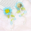 Macro detail of handmade beaded floral earrings with blue petals and white pearls - Blue