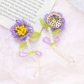Macro detail of hand-woven purple and yellow floral earring with white pearls - Purple
