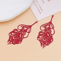 Close-up of red hollow metal peacock feather charms for DIY jewelry and hair accessories - Peacock Feather Hollow Style