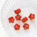 Macro detail of red handmade glass flower beads with hand-painted patterns for DIY jewelry - Red Style (2#)