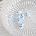 Macro view of white oval ceramic bead with blue polka dots and silver eye pin detail - White with Sky Blue Polka Dots (6#)