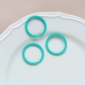 Detailed view of turquoise macaron-colored metal round rings in a white ceramic dish - 39# Large Round Ring (Single)