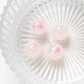 Macro shot of 4 pink translucent heart-patterned beads on a textured glass plate - Price per Piece / Pink Heart Wave Style (1#)