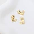 Macro shot of three gold-plated cat charms with zircon collars for DIY jewelry making - 18k Gold Cat Pendant