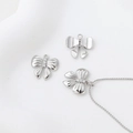 Detailed macro shot of silver bow pendants with zircons for DIY jewelry making - Silver Bowknot Pendant