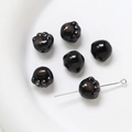 Close-up of a glossy black ceramic cat paw bead on a silver pin for DIY jewelry making - Black Style (7#)