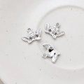 Macro detail of three 14k gold-plated angel pendants for DIY jewelry making - Cherub Style (3# Platinum) / Silver