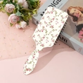 Detail view of pink floral pattern on rectangular cushion hairbrush with a hanging hole - Beige Colorful Floral (B)