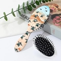 Detail of sea turtle print massage hairbrush set on a stylish lifestyle background - Style C