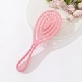 Pink vented hairbrush for scalp massage and volume styling on white aesthetic pedestal - Pink