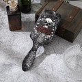 Detail of gothic paddle hairbrush featuring white skull and red roses on distressed back - Red Rose Skull (A)