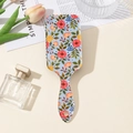 Dettaglio della spazzola per capelli floreale con cuscino d'aria e motivo a fiori - Sfondo Blu Fiori Rosso Arancio (QNS3171-A)