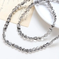 Close-up of heart-shaped smoky grey crystal glass beads for DIY jewelry making - 1 Strand (Approx. 86 Beads) / 8# Grey