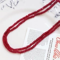 Detailed view of faceted dark red agate beads strand on a vintage white ceramic plate - Deep Red (10# Single Strand)