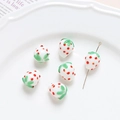 Macro detail of six handmade glass strawberry beads for DIY jewelry making on white ceramic plate - 1# White Strawberry