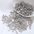 Macro shot of silver hexagonal metal spacer beads for DIY jewelry and bracelet making - Hexagonal Style / 10 Pieces/Pack (4mm) / Silver