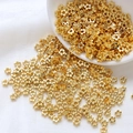 Detailed view of 14k gold-filled plum blossom spacers on white silk for jewelry making - Five-petal Flower Style / 10 Pieces/Pack (4mm) / 18K Gold