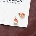 Macro shot of orange-pink teardrop crystal pendants with golden four-prong settings - Style 2 (2#)