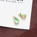 Macro detail of two green pear-shaped crystal pendants with gold claw settings for DIY jewelry - Style 3 (3#)