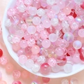 Detailed view of pink DIY glass beads with frosted and crackle textures for jewelry - 75g / Peach Pink Series