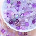 Macro shot of assorted purple DIY beads in various shapes and glass finishes in a tray - 75g / Starry Purple Series