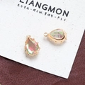 Macro view of teardrop crystal pendants with faceted rainbow hues and golden claw settings - Style 14 (14#)