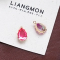 Close-up of teardrop crystal pendants in pink and iridescent hues with gold metal claw settings - Style 20 (20#)
