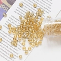 Macro shot of 4mm glass beads with gold foil lining for DIY jewelry crafting - Apricot