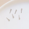 Macro shot of 6 silver twisted metal pins with bead heads for DIY jewelry making - White K/Silver