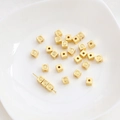 Detailed macro view of 14K gold-plated square smile face spacer beads for DIY jewelry - 18K Gold
