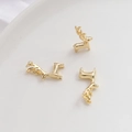 Detailed view of three gold-plated deer charms for DIY jewelry making on white tray - Reindeer Pendant / 18K Gold