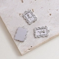 Macro shot of silver retro rose relief pendants showing baroque carved details and texture - Silver Oval Rose (7#)