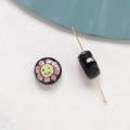 Macro detail of black ceramic flower bead with smiley face for DIY jewelry crafting - Sunflower Style (4#)