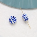 Detail of blue and white ceramic beads showing hole structure with a metal pin for jewelry DIY - Blue and White Porcelain Style (6#)