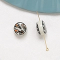 Macro detail of round flat ceramic beads with orange leaf pattern and threading structure - Leaf Pattern Style (10#)