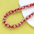 Detailed view of handmade red lampwork glass beads with white and yellow flower patterns - 2# Red