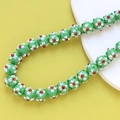 Macro shot of green lampwork glass floral beads with detailed white petals for DIY jewelry - 3# Green