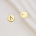 Macro detail of gold-plated letter A pendant with cubic zirconia inlay and back holes - Letter A / Gold