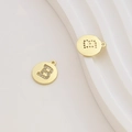Macro shot of 18k gold-plated letter B pendant with micro-set cubic zirconia stones - Letter B / Gold