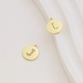 Detailed macro view of 18k gold-plated letter J pendants with inlaid zircon and black dots - Letter J / Gold