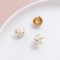Detailed macro view of gold-plated broken eggshell earrings with colorful heart patterns - K Gold
