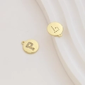 Macro detail of gold-plated letter P pendant with zircon inlay for DIY jewelry - Letter P / Gold