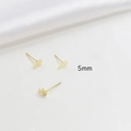 Close-up of 5mm gold plated flat stud earrings with hanging loop for DIY jewelry making - 5mm / 14K Gold